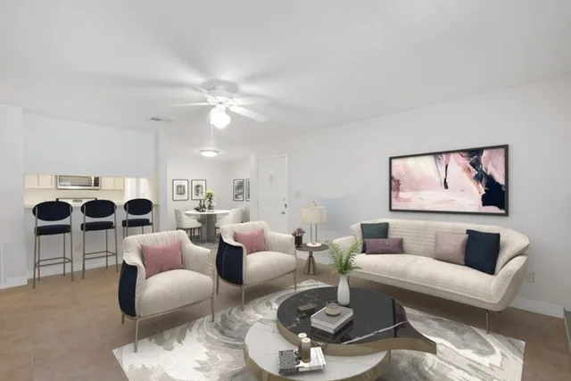 a living room with furniture couches and a flat screen tv