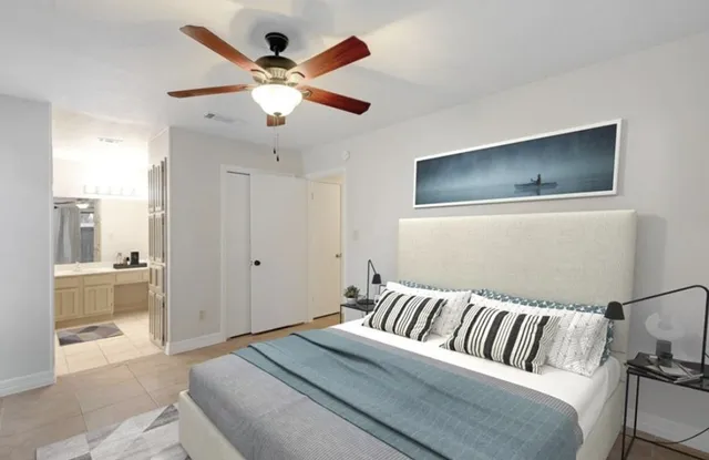 a living room with a large bed and a chandelier