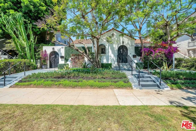 a front view of a house with a yard and a garage