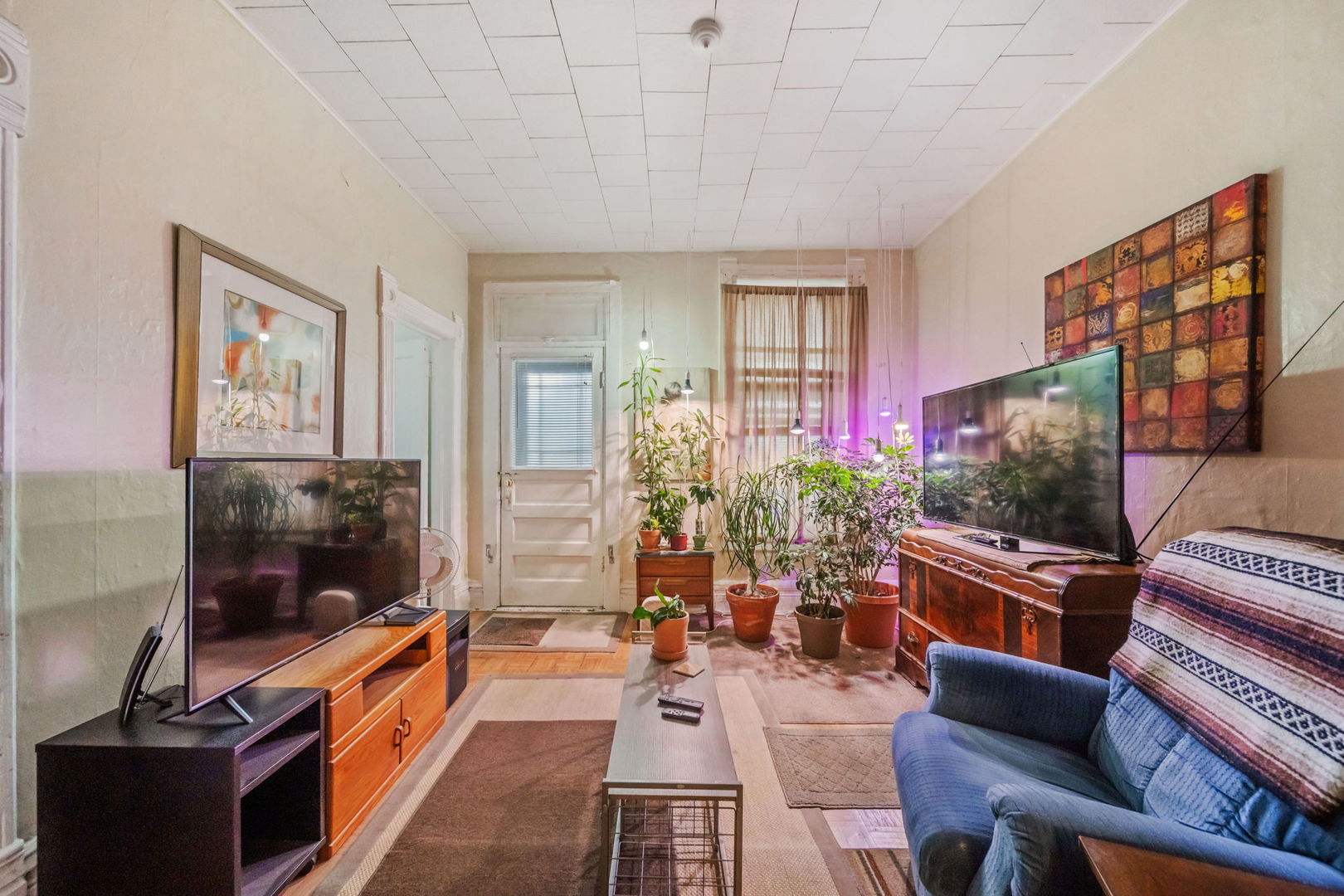 2236 West 19th Street Chicago, IL 60608 - Photo 18 of 40 a living room with furniture a flat screen tv and a floor to ceiling window