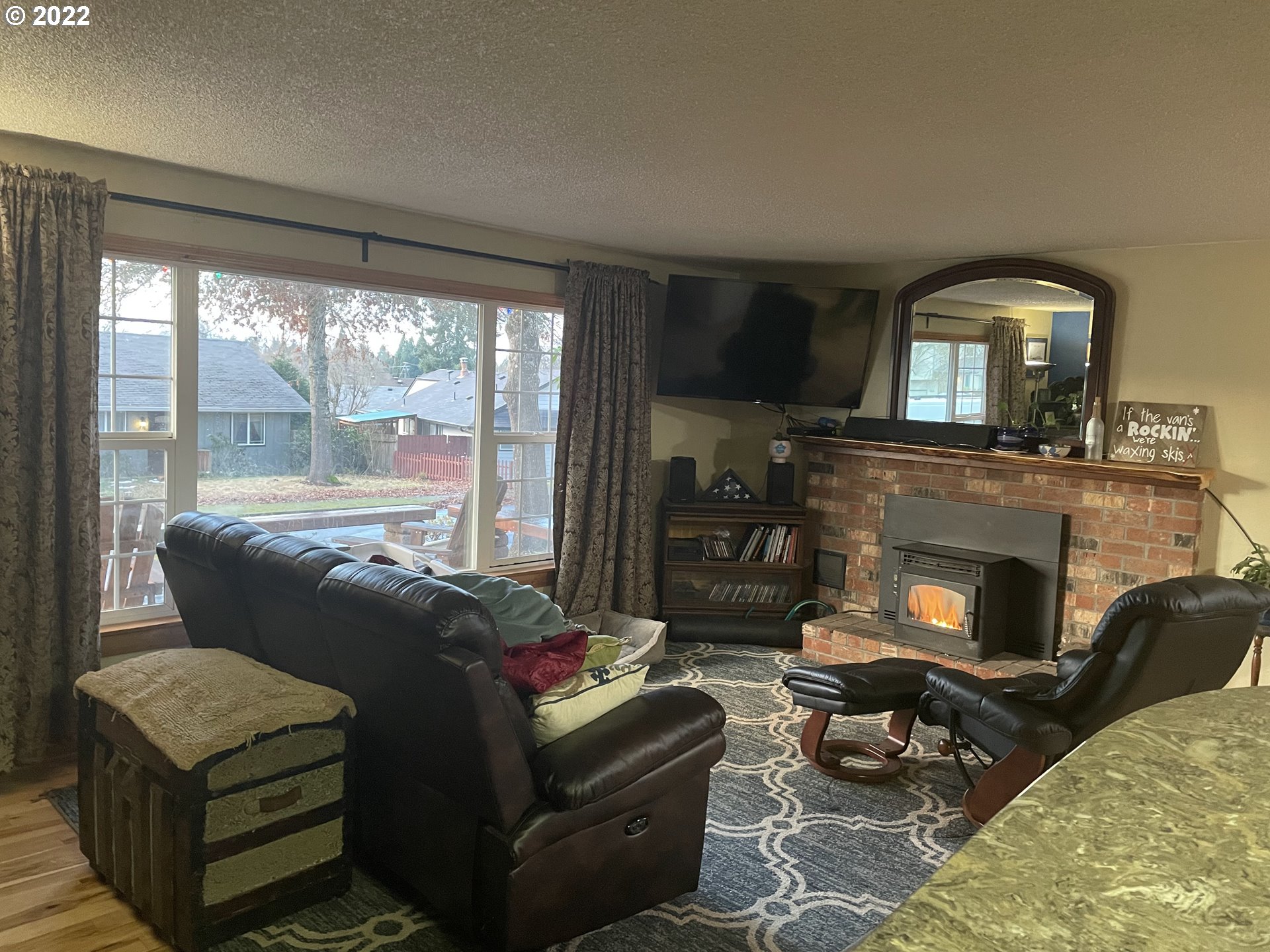 541 Hamilton Street Springfield, OR 97477 - Photo 13 of 15 a living room with furniture a fireplace and a floor to ceiling window