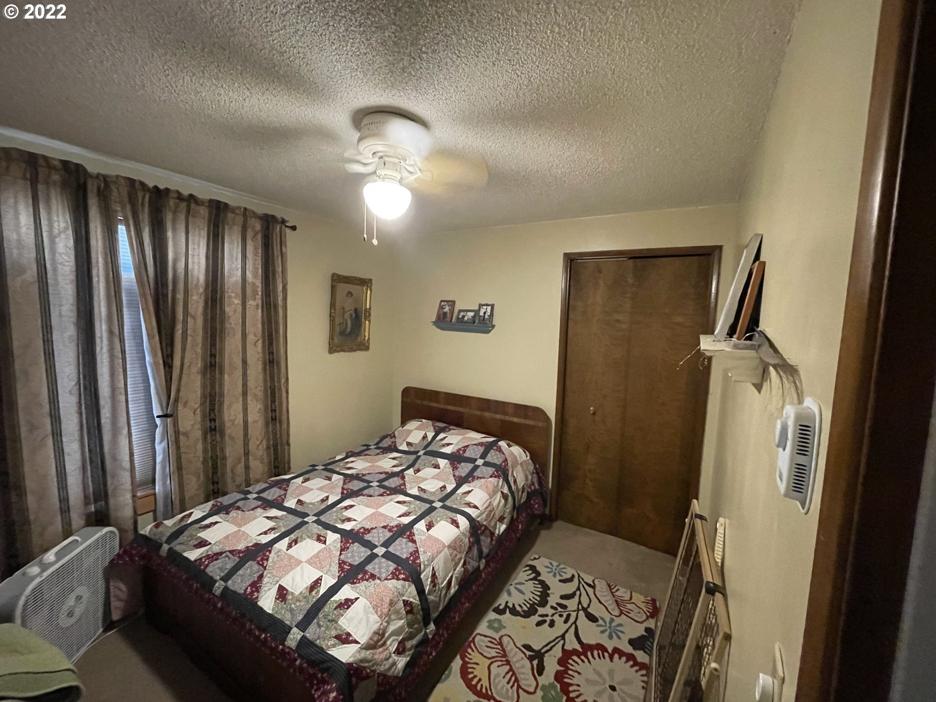541 Hamilton Street Springfield, OR 97477 - Photo 5 of 15 a bedroom with a bed and a chandelier