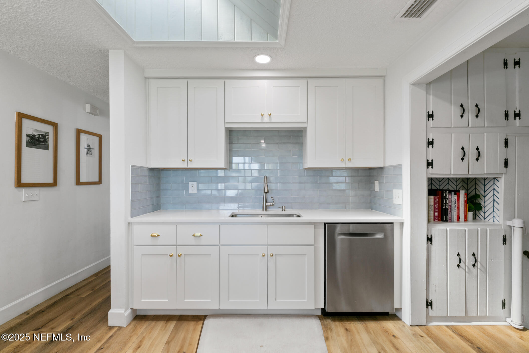 452 Sargo Road Atlantic Beach, FL 32233 - Photo 20 of 74 a kitchen with white cabinets and sink