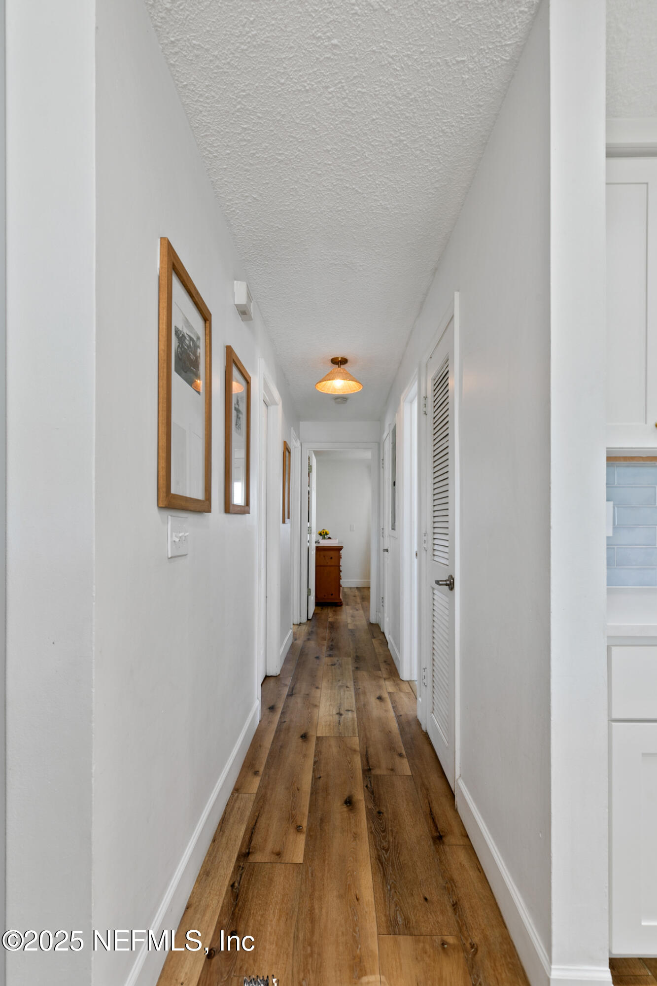 452 Sargo Road Atlantic Beach, FL 32233 - Photo 30 of 74 a view of a hallway with wooden floor and furniture