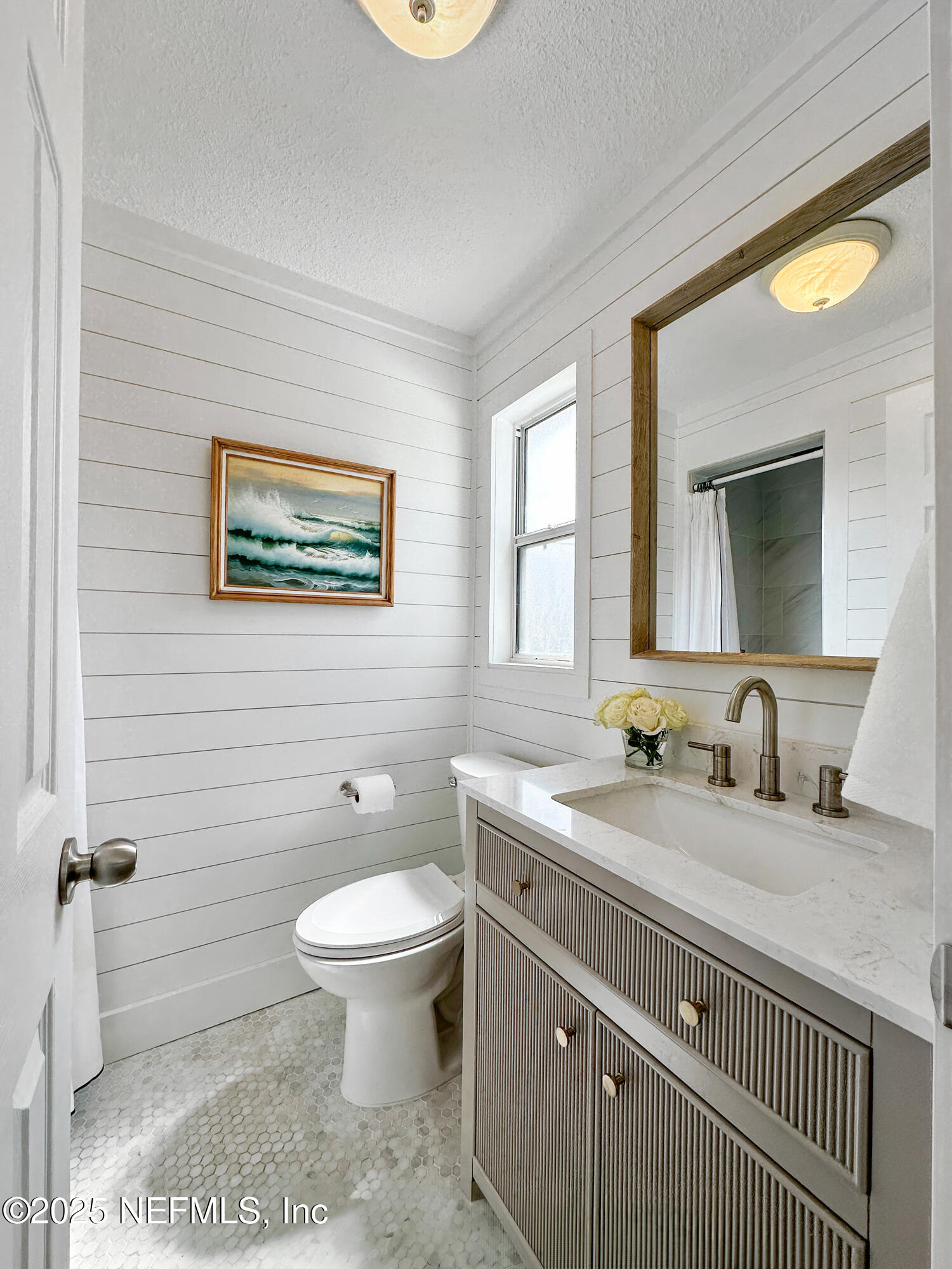 452 Sargo Road Atlantic Beach, FL 32233 - Photo 34 of 74 a bathroom with a granite countertop toilet sink and mirror