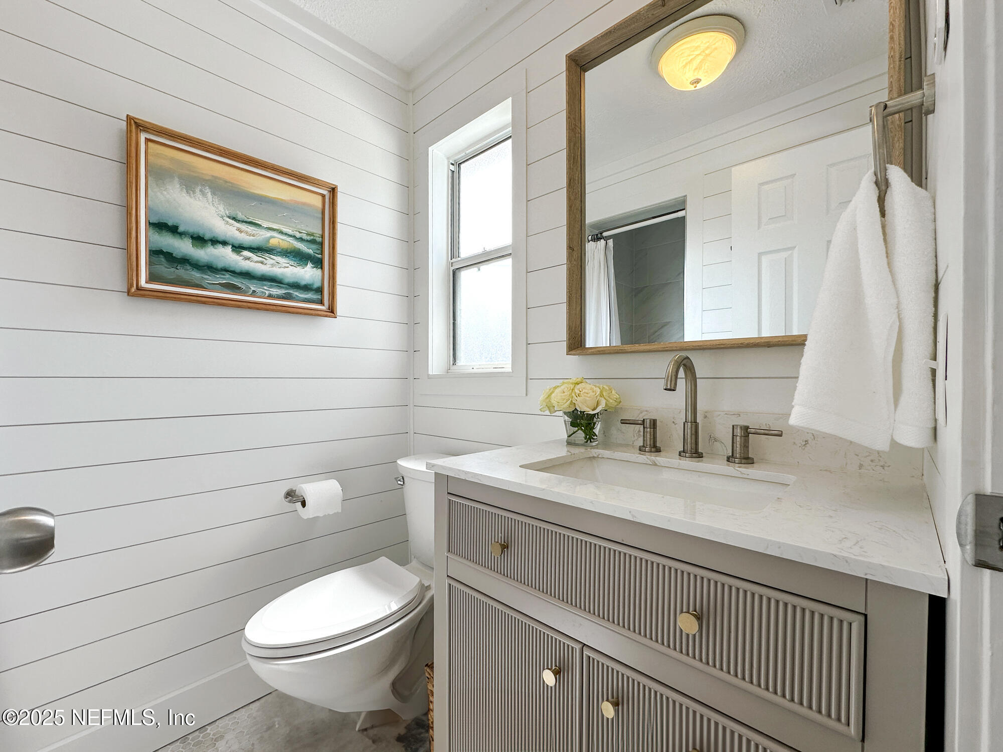 452 Sargo Road Atlantic Beach, FL 32233 - Photo 35 of 74 a bathroom with a granite countertop toilet sink and mirror