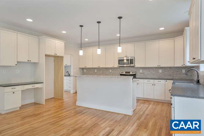 128 Wexford Ridge Road Ruckersville, VA 22968 - Photo 13 of 19 a kitchen with stainless steel appliances granite countertop a refrigerator a sink dishwasher a stove and white cabinets with wooden floor