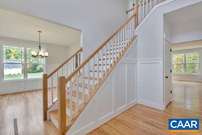 128 Wexford Ridge Road Ruckersville, VA 22968 - Photo 14 of 19 a view of staircase with wooden floor and pendant lights