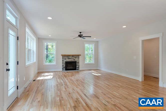 128 Wexford Ridge Road Ruckersville, VA 22968 - Photo 15 of 19 a view of an empty room with wooden floor fireplace and a window