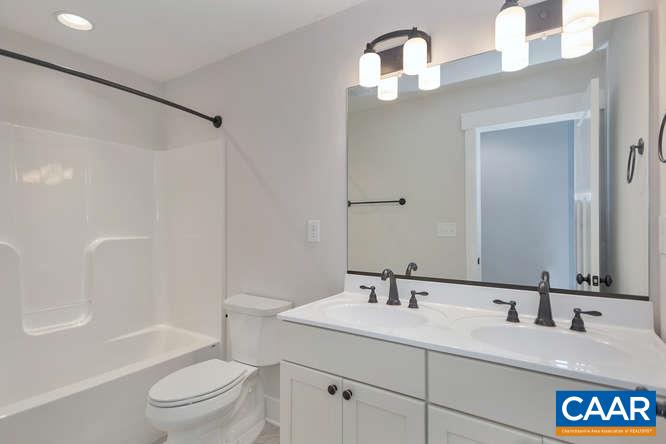 128 Wexford Ridge Road Ruckersville, VA 22968 - Photo 19 of 19 a bathroom with a granite countertop sink toilet and shower