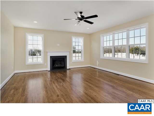 128 Wexford Ridge Road Ruckersville, VA 22968 - Photo 4 of 19 a living room with a fireplace wooden floor and a window