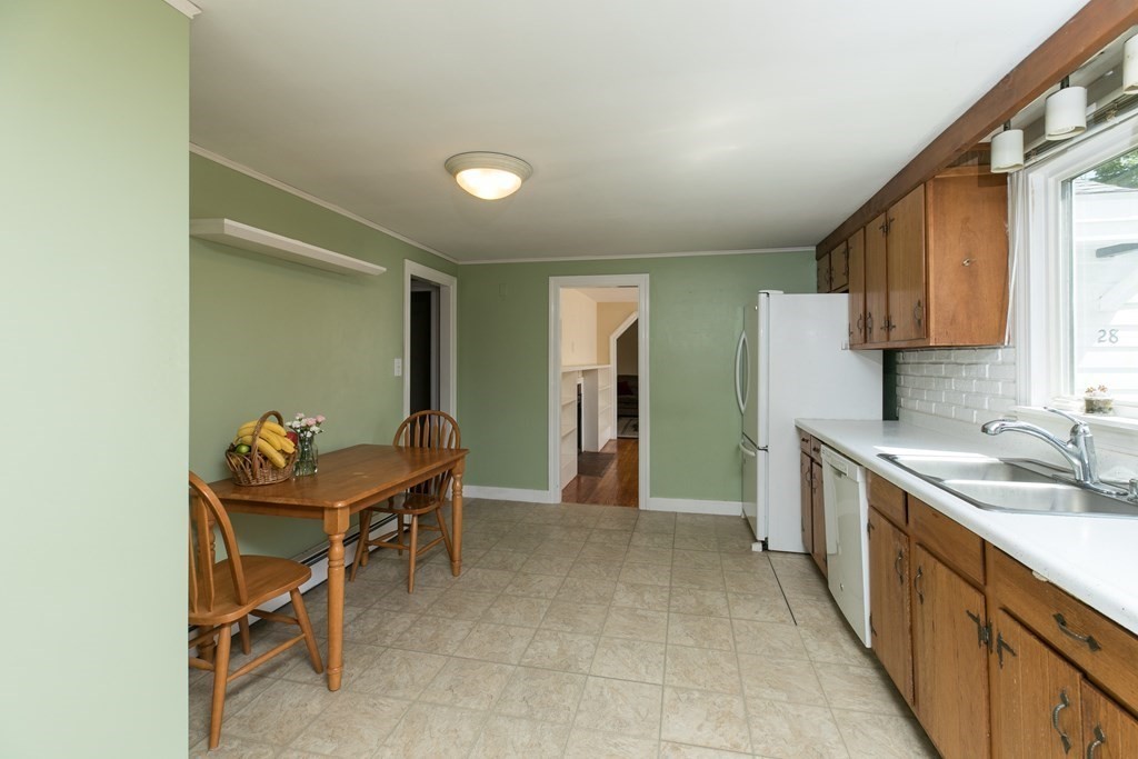 28 Norman Road Hamilton, MA 01982 - Photo 7 of 19 a kitchen with stainless steel appliances granite countertop a sink and a refrigerator