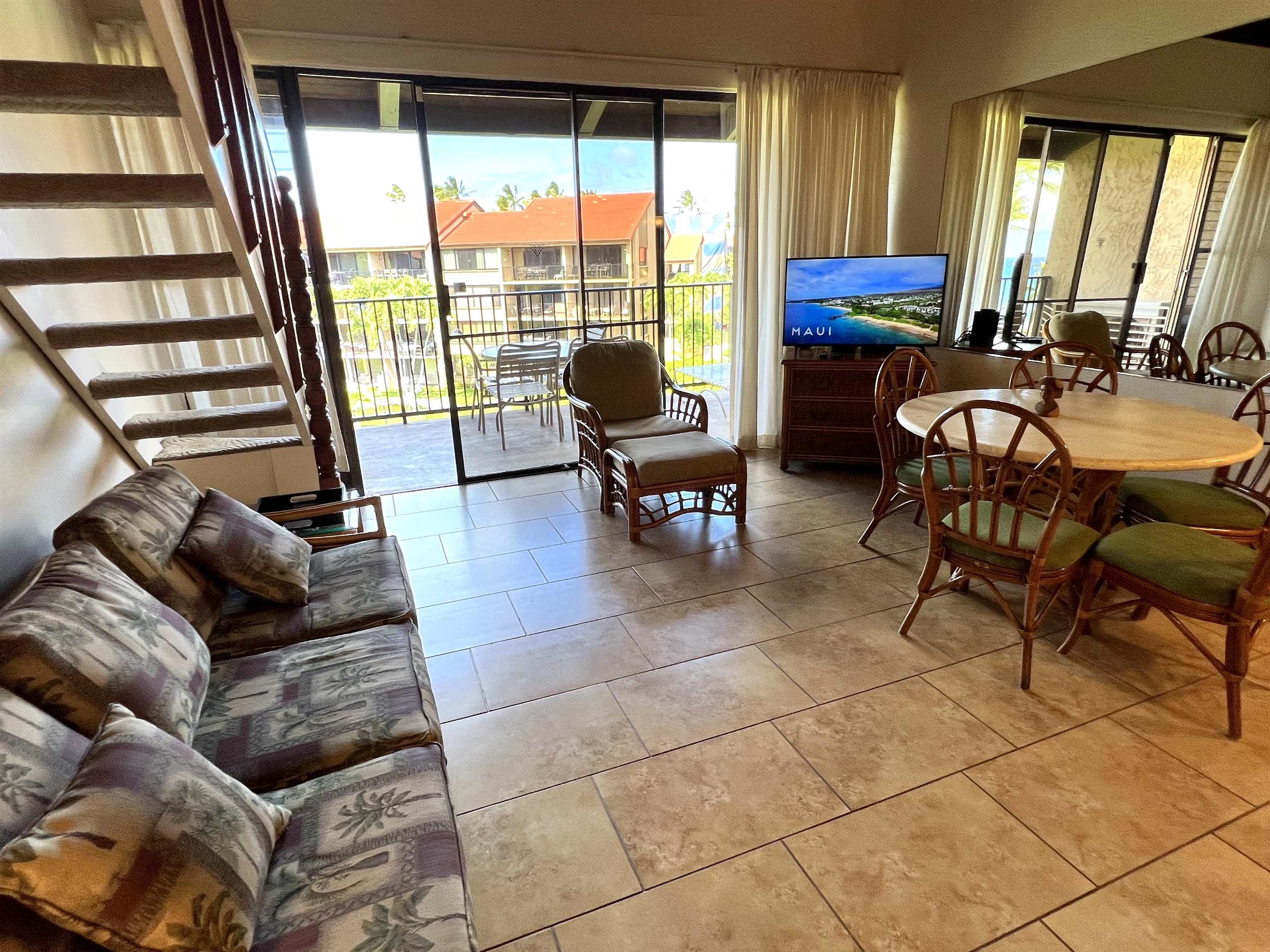 3543 Lower Honoapiilani Road, Unit J403 Lahaina, HI 96761 - Photo 16 of 23 a living room with furniture and a floor to ceiling window