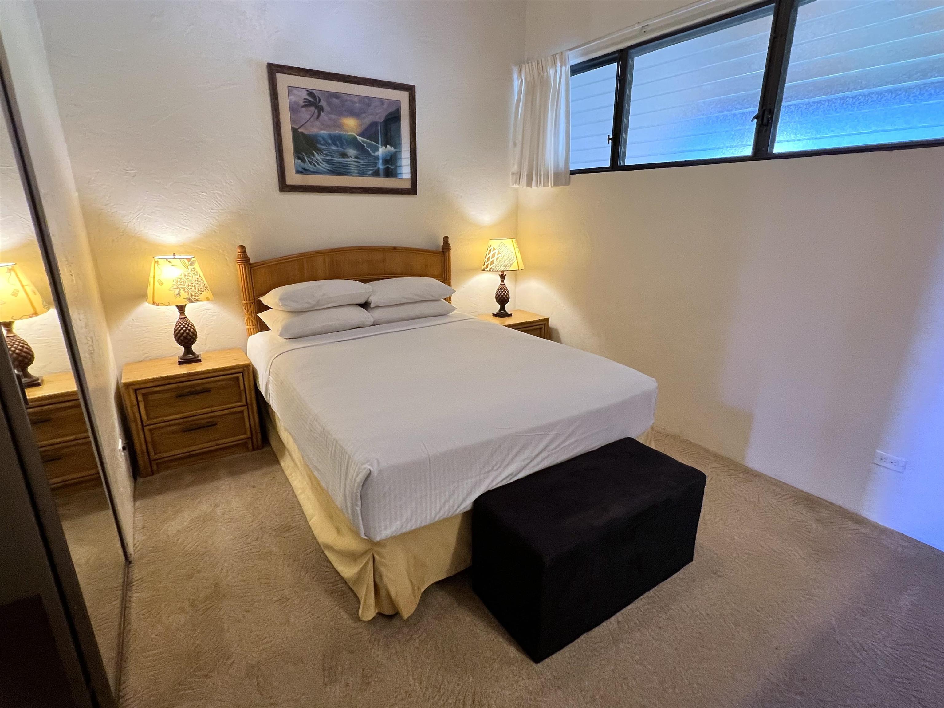 3543 Lower Honoapiilani Road, Unit J403 Lahaina, HI 96761 - Photo 2 of 23 a bedroom with a bed and wooden floor