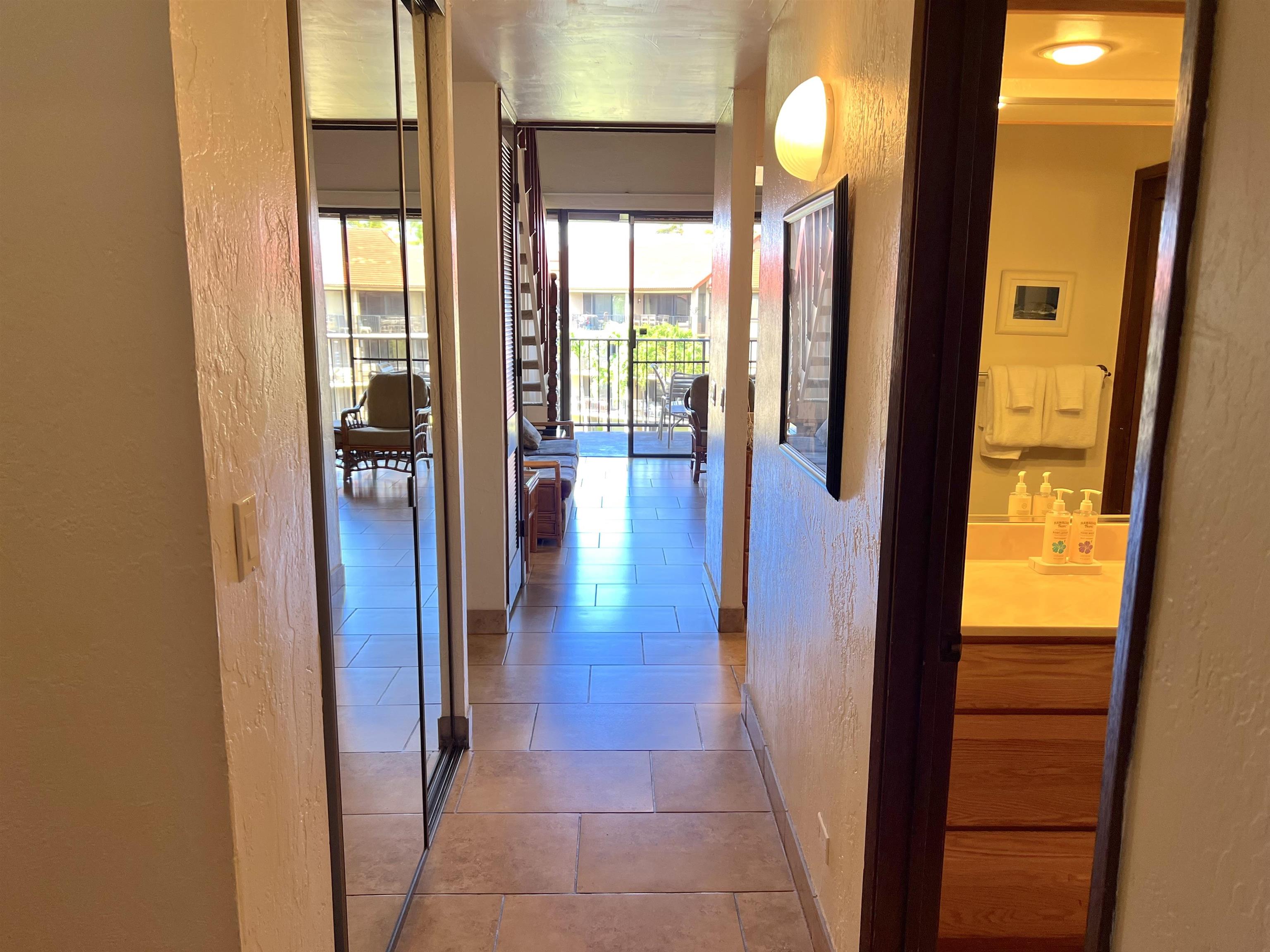 3543 Lower Honoapiilani Road, Unit J403 Lahaina, HI 96761 - Photo 4 of 23 a view of a hallway with wooden floor and windows
