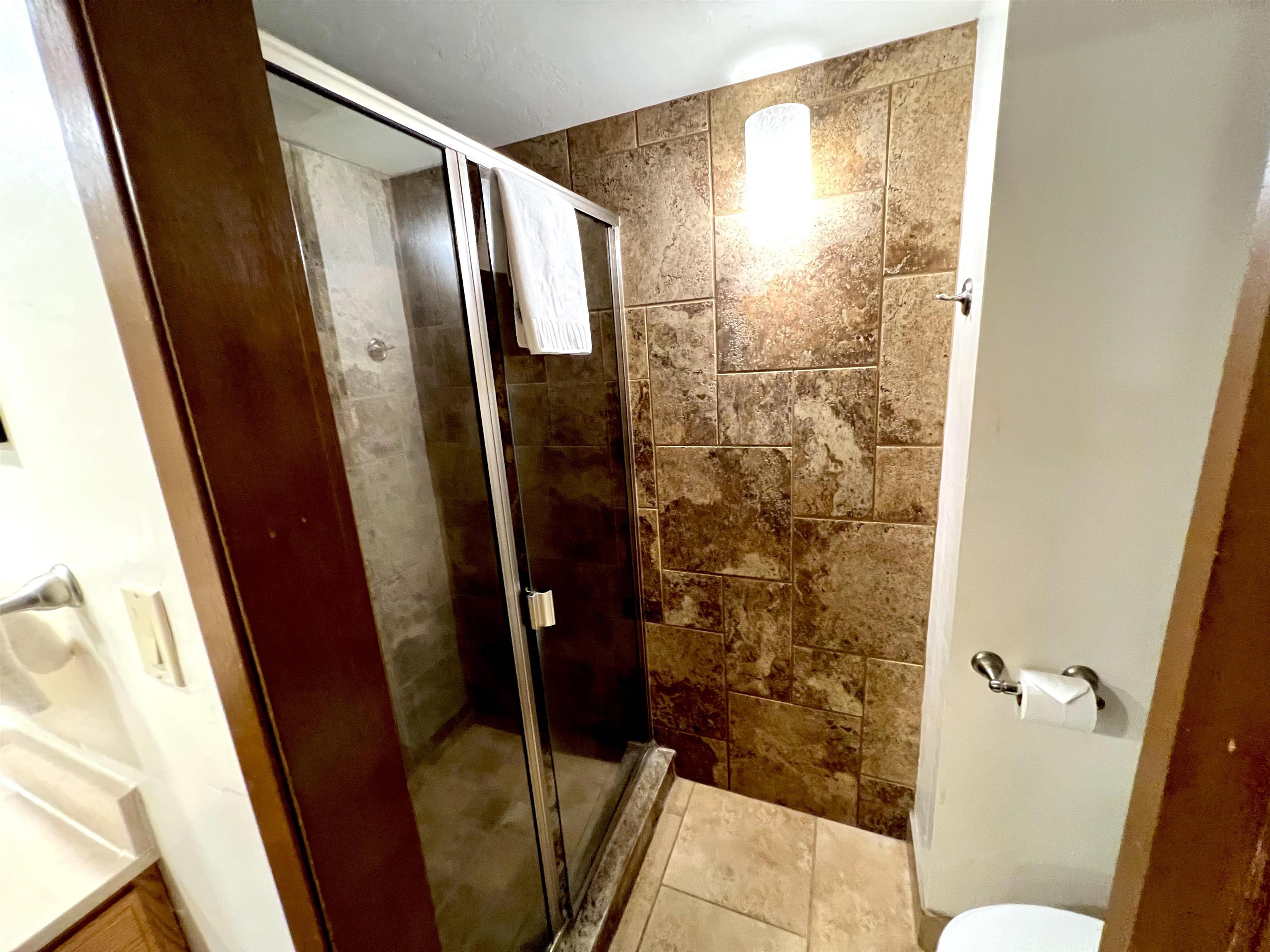 3543 Lower Honoapiilani Road, Unit J403 Lahaina, HI 96761 - Photo 6 of 23 a bathroom with a shower and toilet