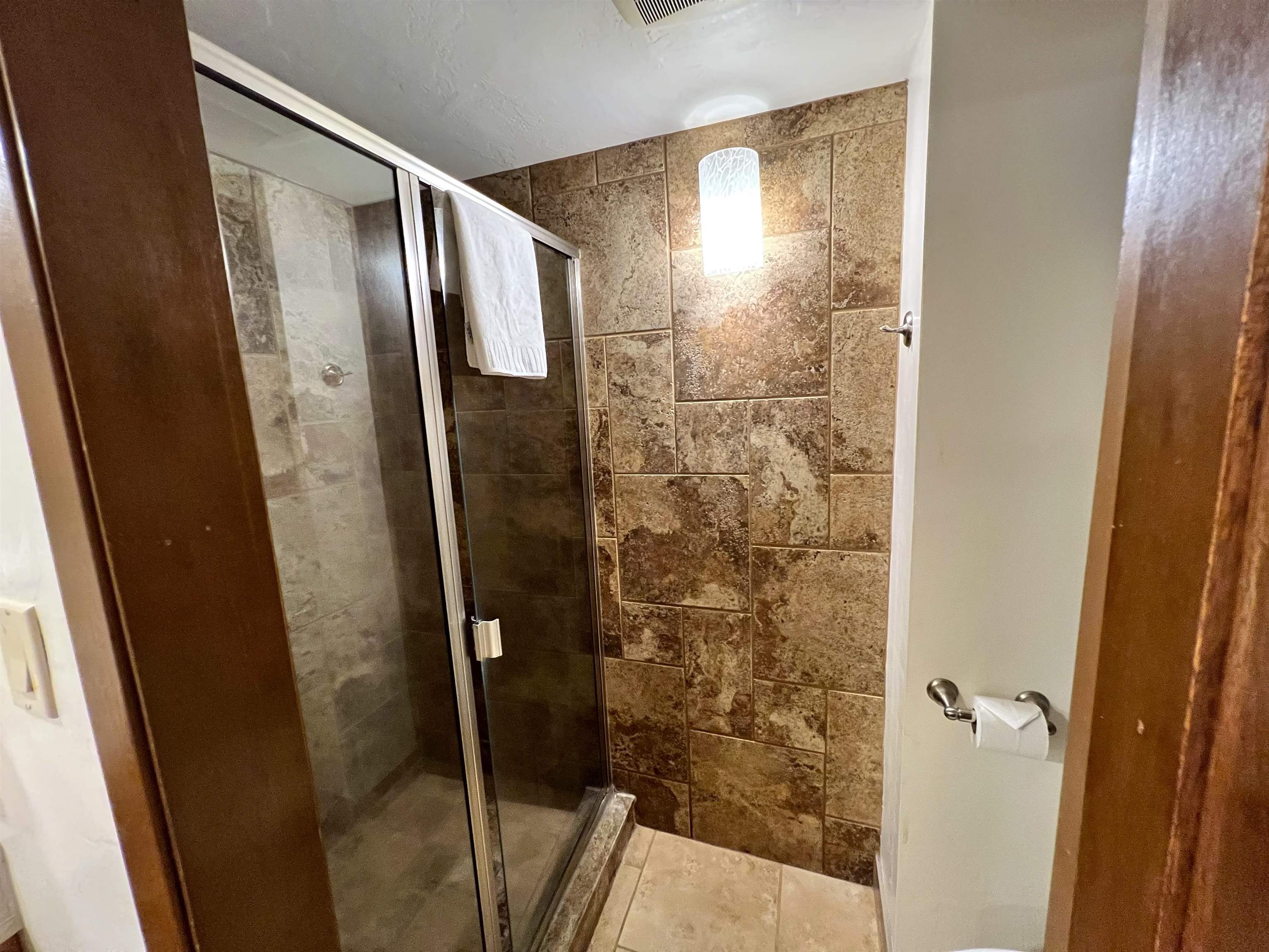 3543 Lower Honoapiilani Road, Unit J403 Lahaina, HI 96761 - Photo 7 of 23 a bathroom with a glass door shower and a sink