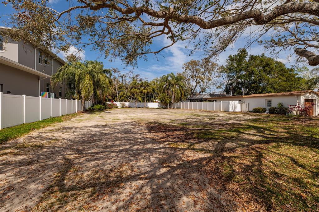 446 Rafael Boulevard Northeast St. Petersburg, FL 33704 - Photo 2 of 20 a view of a yard with wooden fence