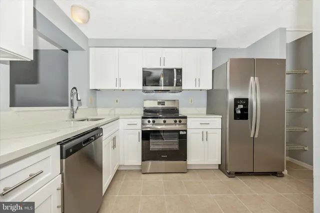 a kitchen with a stove sink and refrigerator