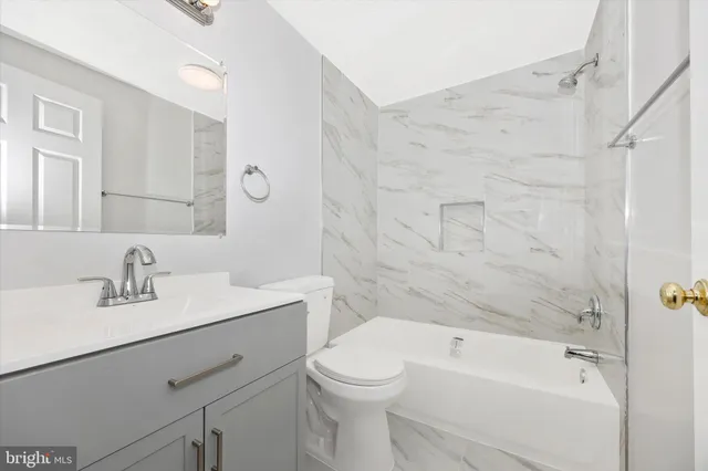 a bathroom with a sink toilet vanity and shower