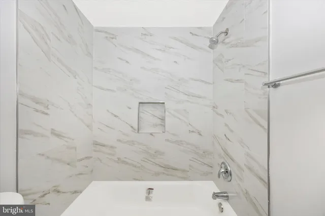 a bathroom with a bathtub and shower