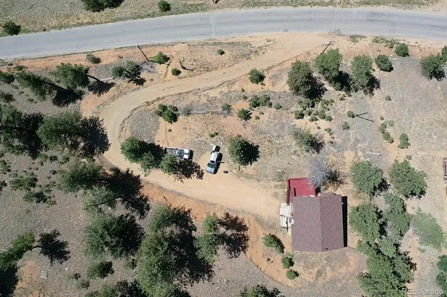 an aerial view of a house with a yard