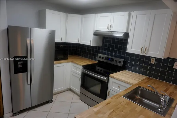 a kitchen with appliances and cabinets