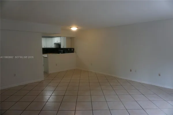 wooden floor in an empty room with a kitchen