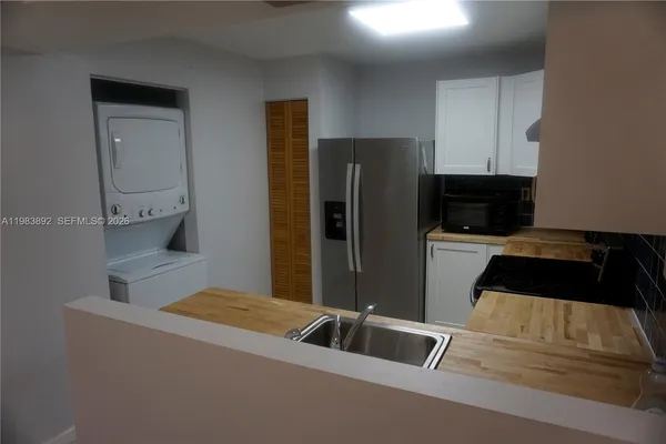 a kitchen with a refrigerator and a sink