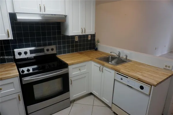 a kitchen with a stove and a sink
