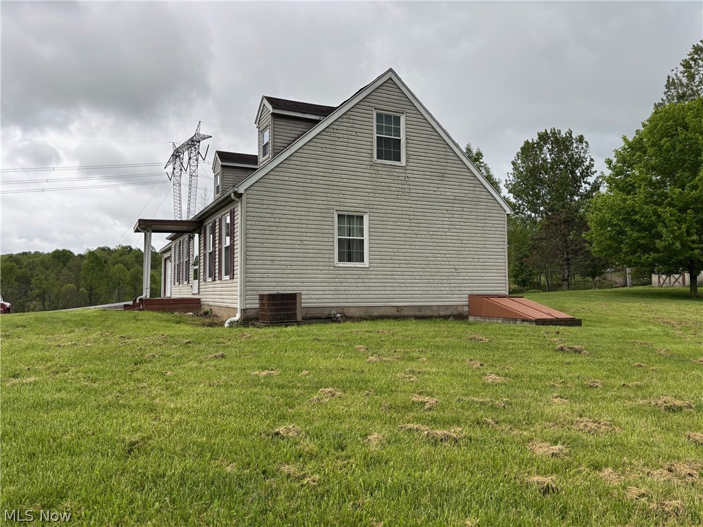 57575 Marietta Road Byesville, OH 43723 - Photo 23 of 25 Two-story residence featuring light-colored siding, a covered porch, and dual dormer windows