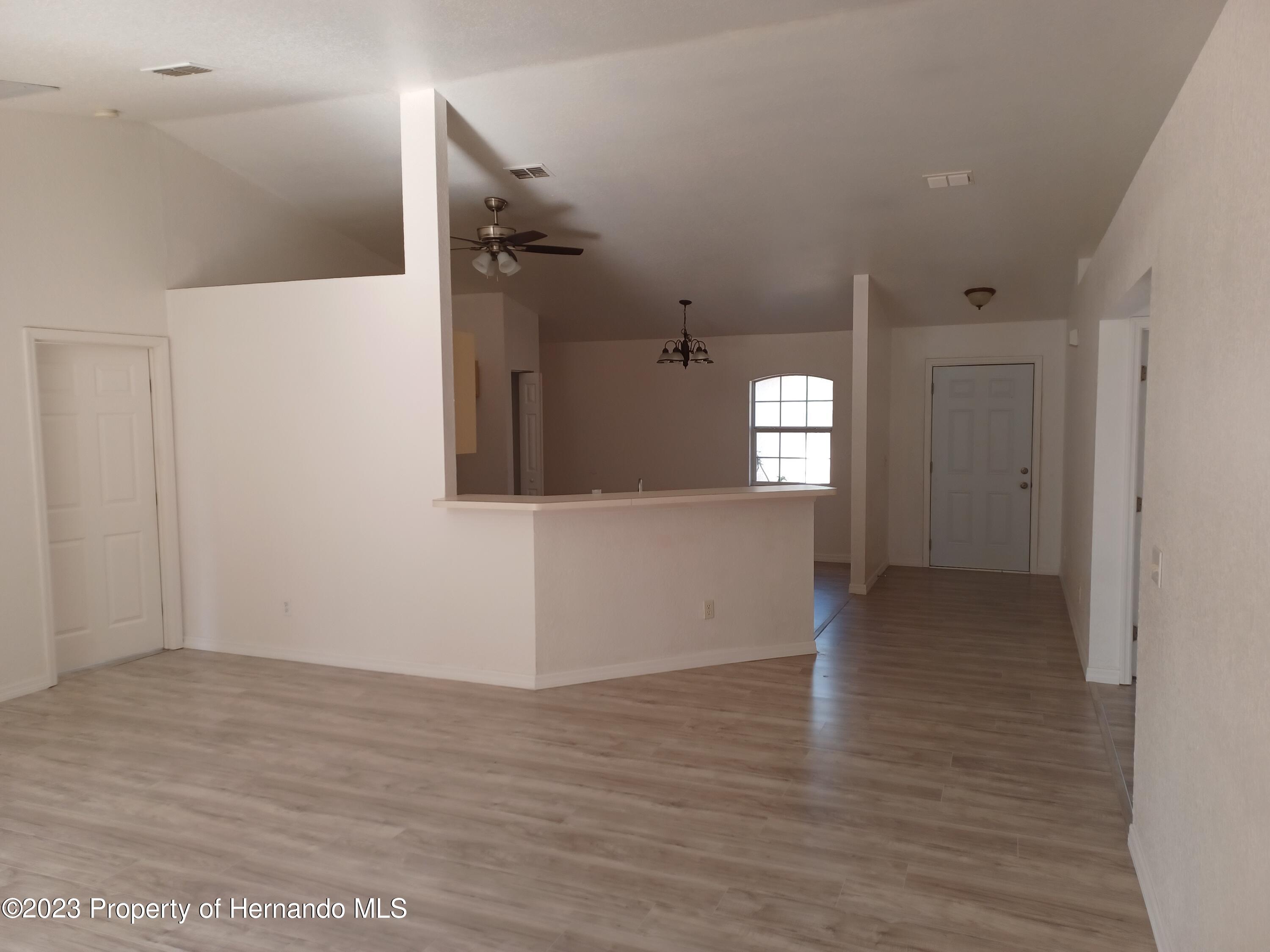 2790 Southwest 165th Street Road Ocala, FL 34473 - Photo 40 of 55 a view of a big room with wooden floor and windows