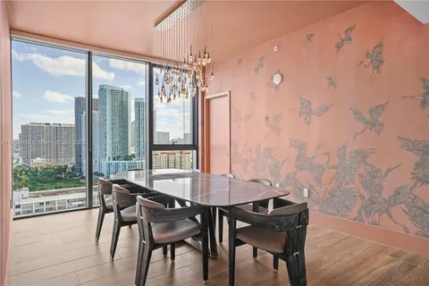 a view of a dining room with furniture wooden floor and a chandelier