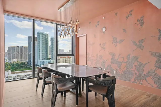 a view of a dining room with furniture wooden floor and a chandelier