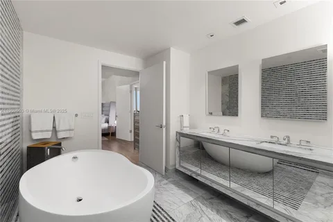 a bedroom with a bed and glass window