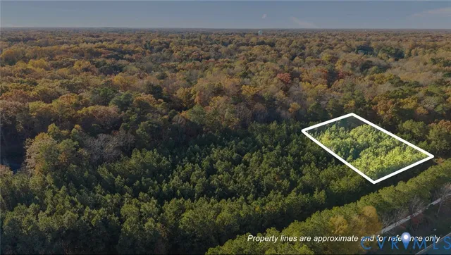 an aerial view of residential building with trees