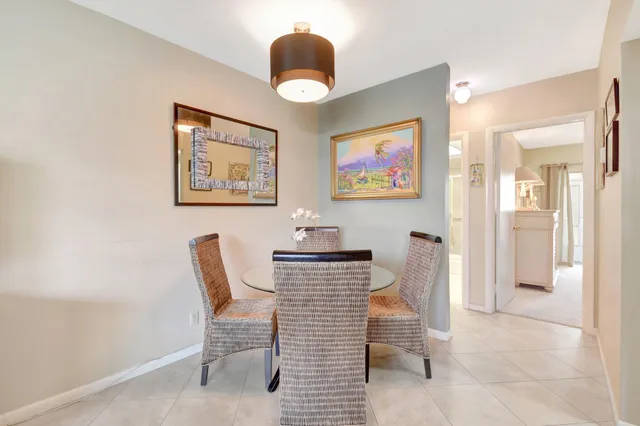 a view of a dining room with furniture and a large window