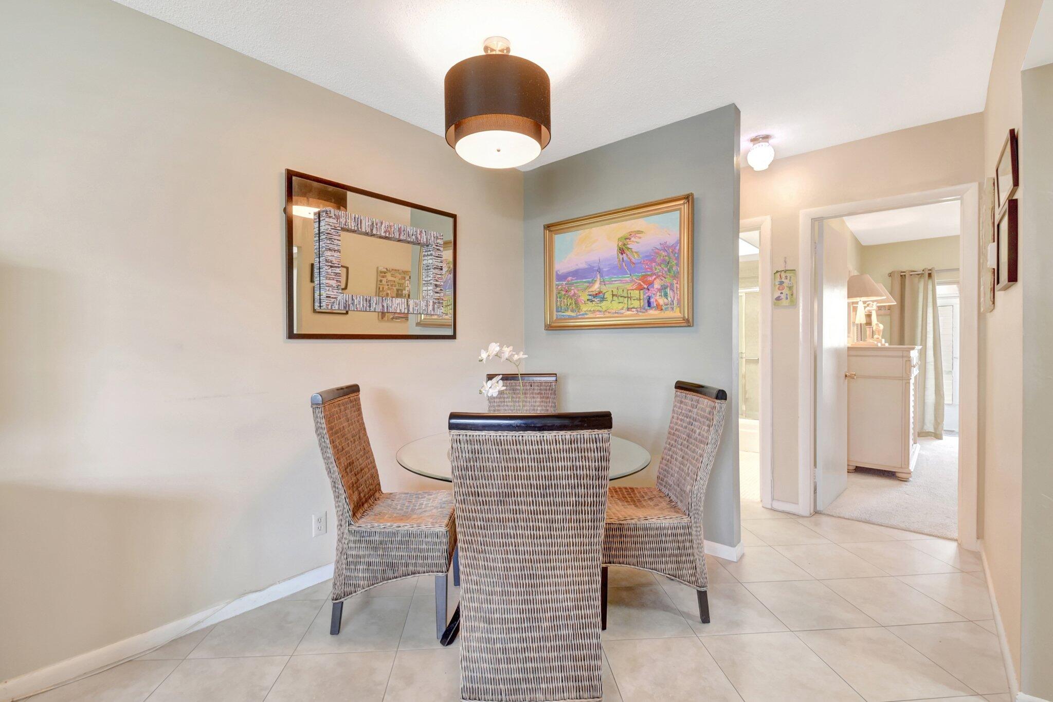 5505 North Ocean Boulevard, Unit 13105 Ocean Ridge, FL 33435 - Photo 13 of 40 a view of a dining room with furniture and a large window