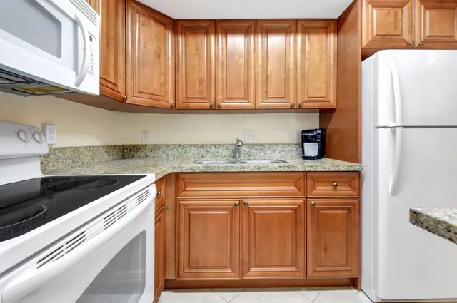 a kitchen with appliances cabinets and a counter top space