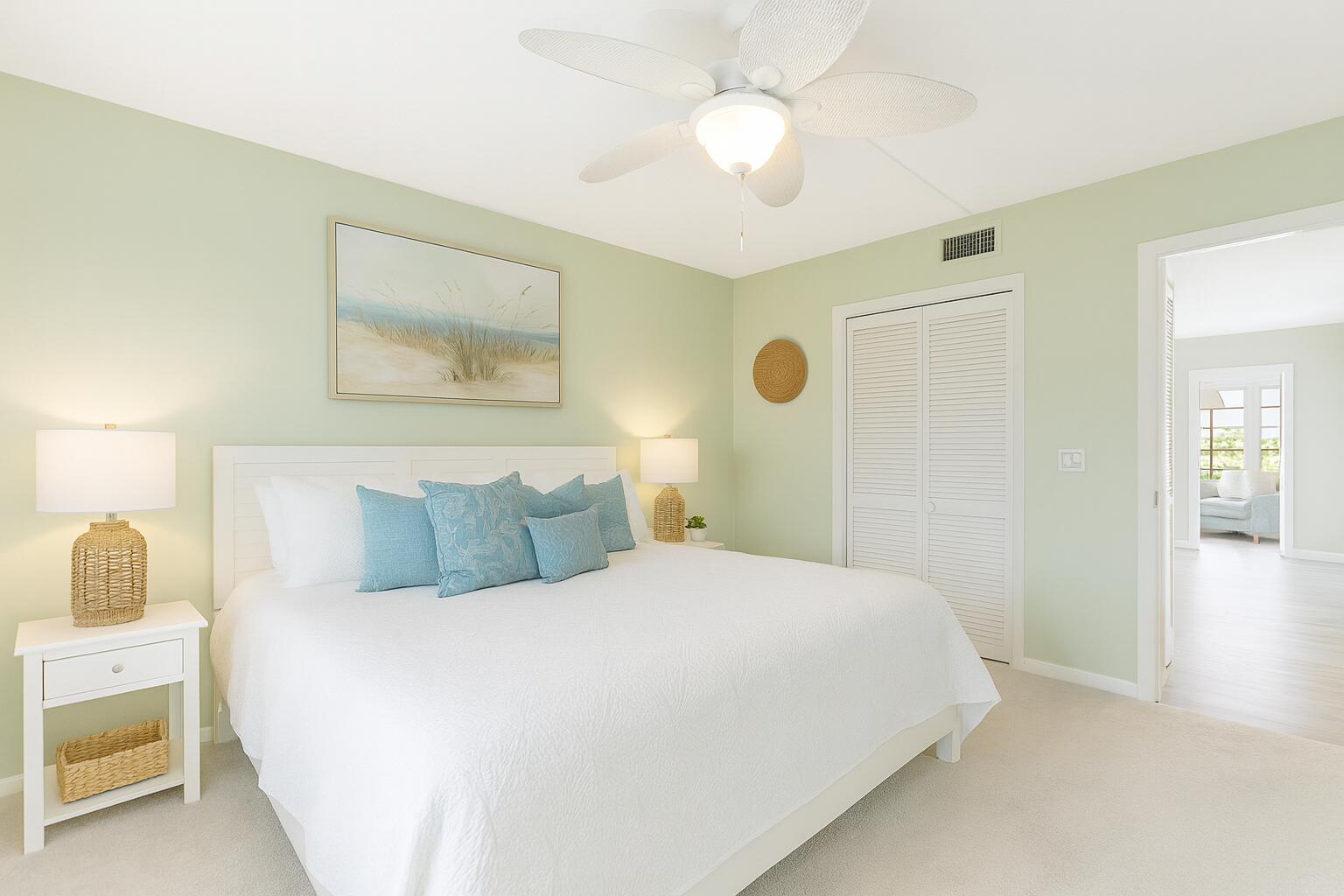 5505 North Ocean Boulevard, Unit 13105 Ocean Ridge, FL 33435 - Photo 24 of 40 a bedroom with a bed and a chandelier