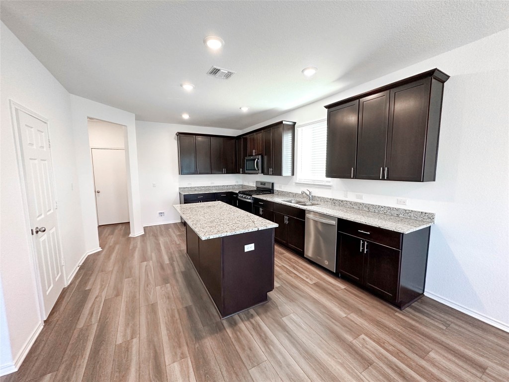 925 Duskywing Way Georgetown, TX 78626 - Photo 4 of 28 Granite counters, Stainless appliances in a bright kitchen with large island