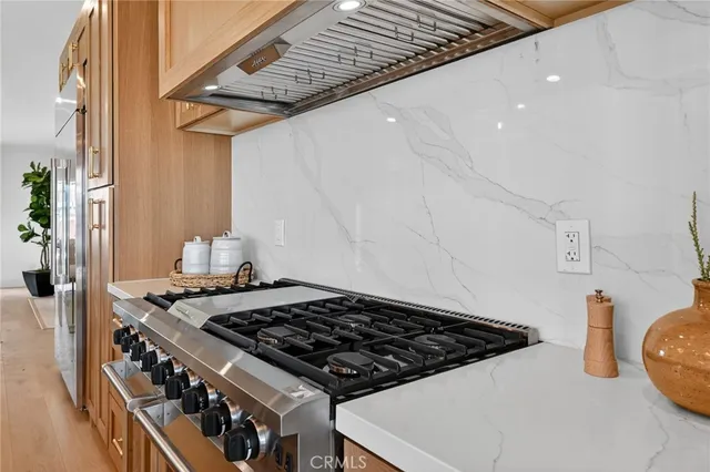 a living room with furniture a fireplace and a potted plant