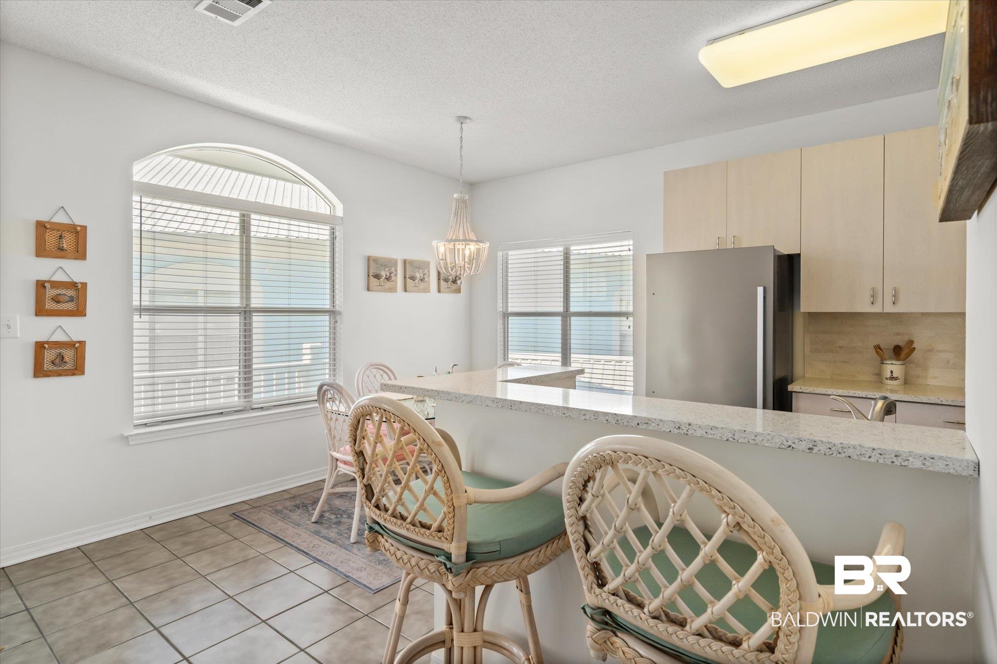 3575 Bayou Road, Unit A 10 Orange Beach, AL 36561 - Photo 10 of 31 Kitchen with light Quartz counters, pendant lighting, light tile patterned floors, cream cabinets, and new stainless steel appliances
