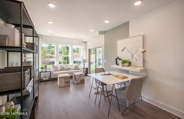 a view of a dining room with furniture window and wooden floor