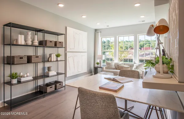 a living room with furniture and a floor to ceiling window