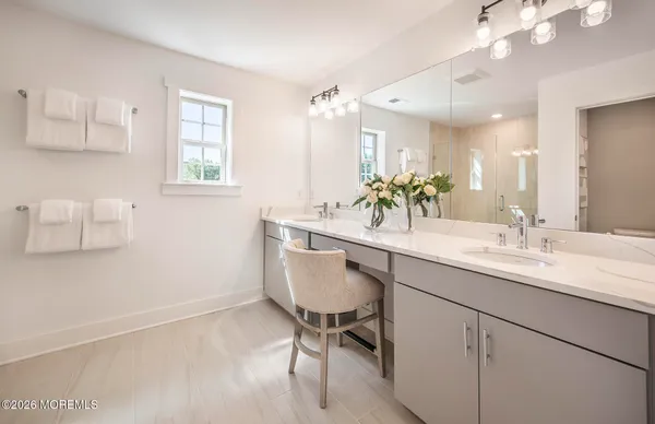 a bathroom with a sink double vanity and a mirror