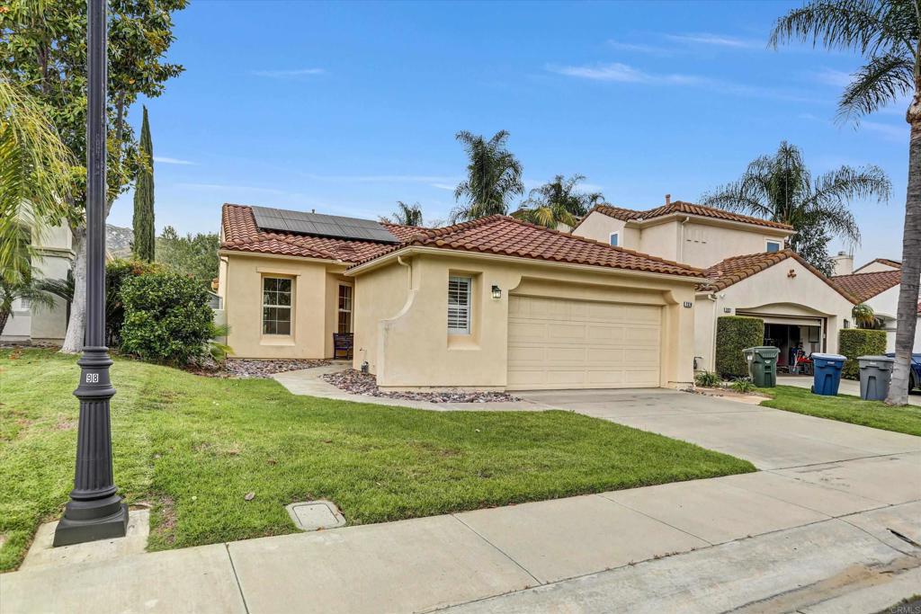 a front view of a house with a garden and yard