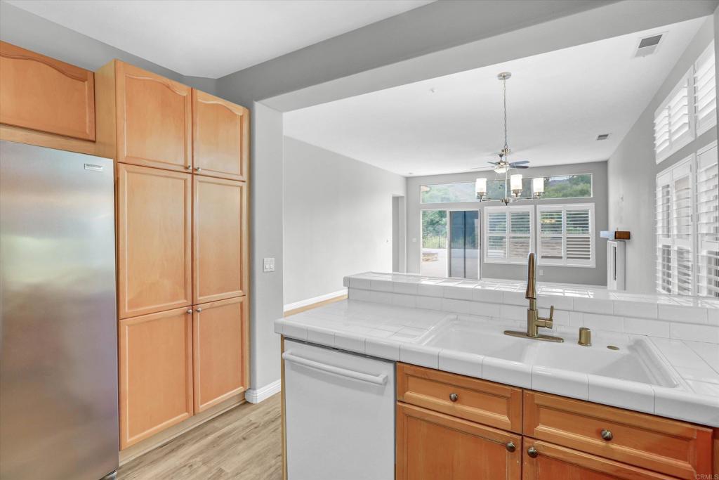 2318 Fallbrook Place Escondido, CA 92027 - Photo 13 of 34 a kitchen with stainless steel appliances granite countertop a sink and a refrigerator