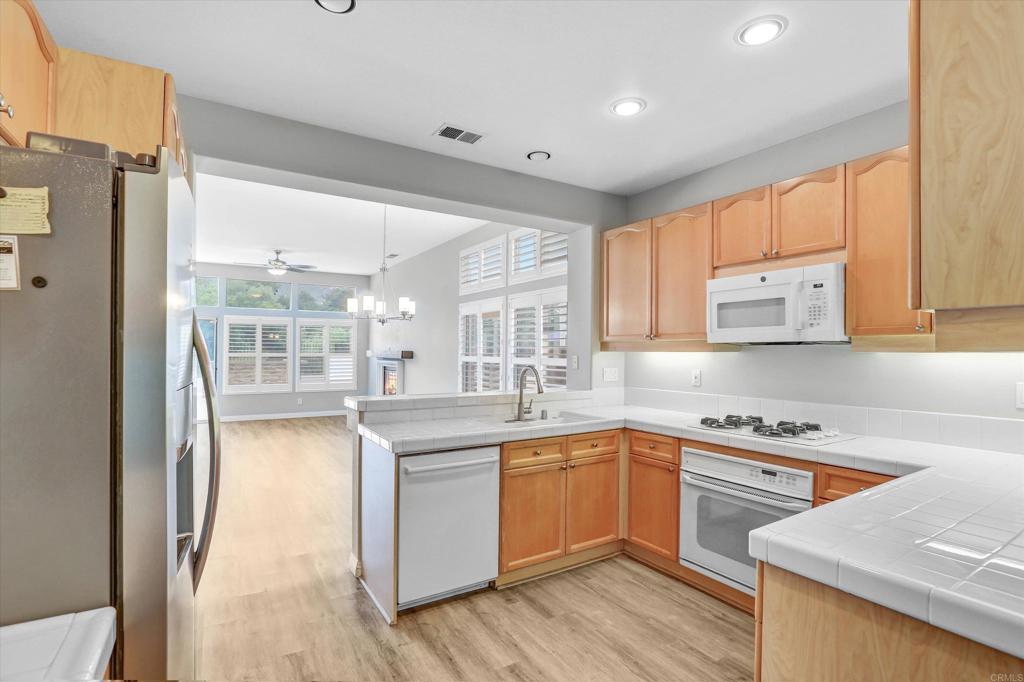 2318 Fallbrook Place Escondido, CA 92027 - Photo 14 of 34 a kitchen with a sink stove and cabinets