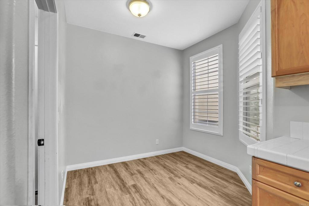 2318 Fallbrook Place Escondido, CA 92027 - Photo 15 of 34 a view of an empty room with wooden floor and a window